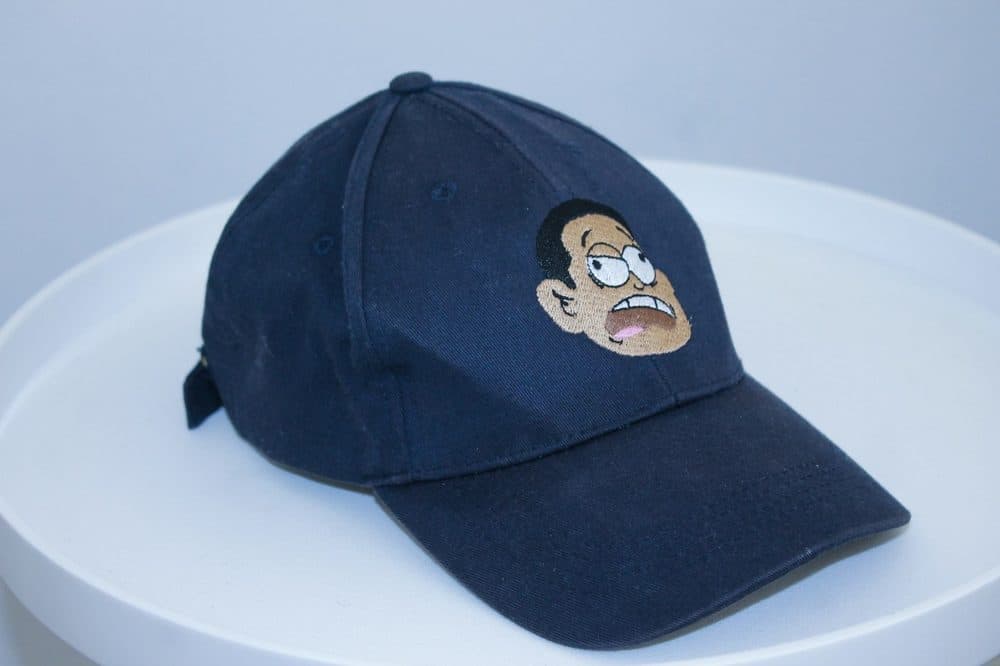 Close-up of a navy baseball cap with an embroidered front patch