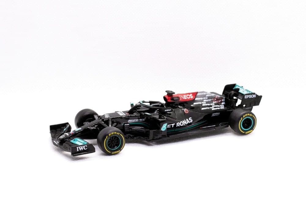 Black and teal Formula 1 scale model on a white background